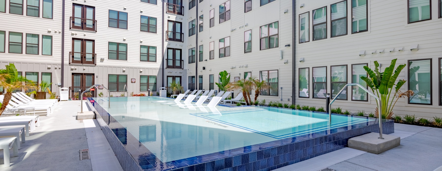 Swimming pool with chair at SOFI modern apartments in Austin